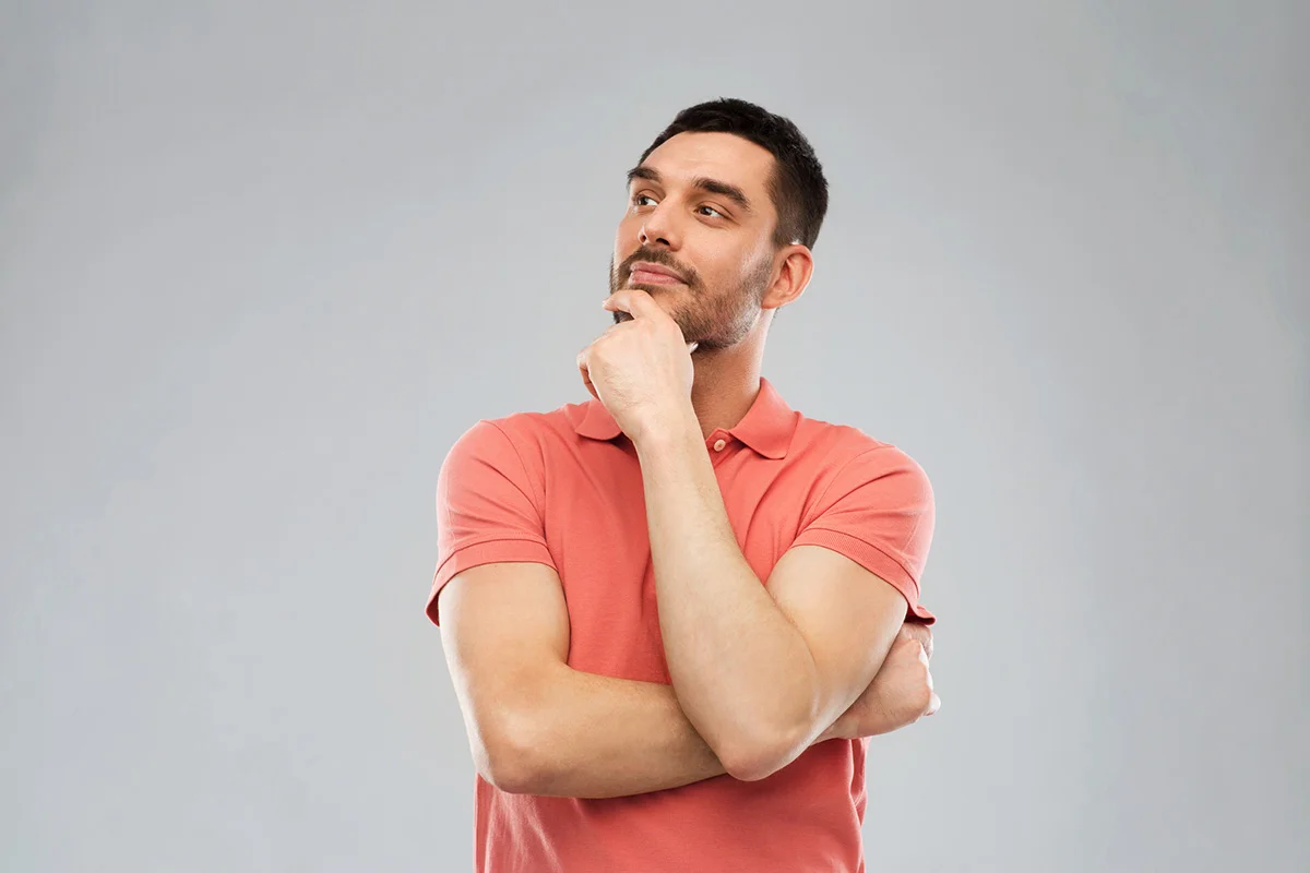 man in polo t-shirt thinking over gray background Dental Questions | Somerset Dental on James