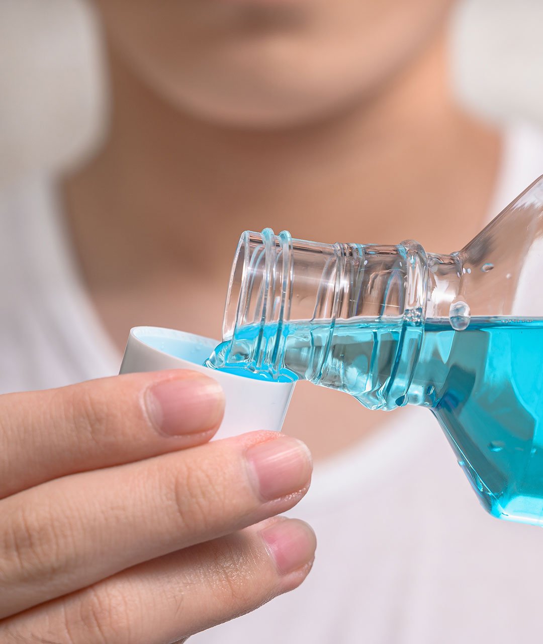 man-pouring-mouthwash-water-cap